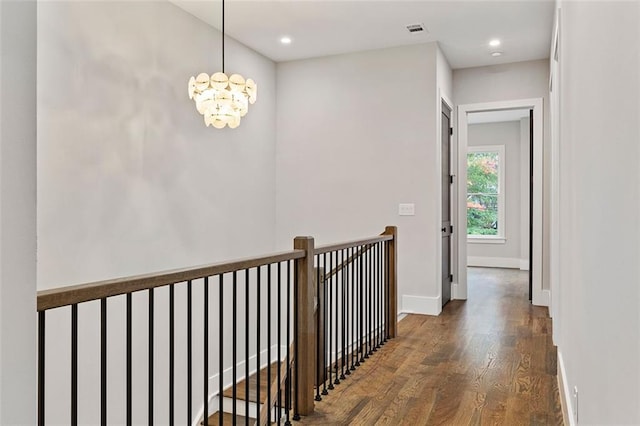 660 Timm Valley Rd NE, Atlanta, GA 30305 - corridor with an upstairs landing, baseboards, visible vents, a notable chandelier, and wood finished floors