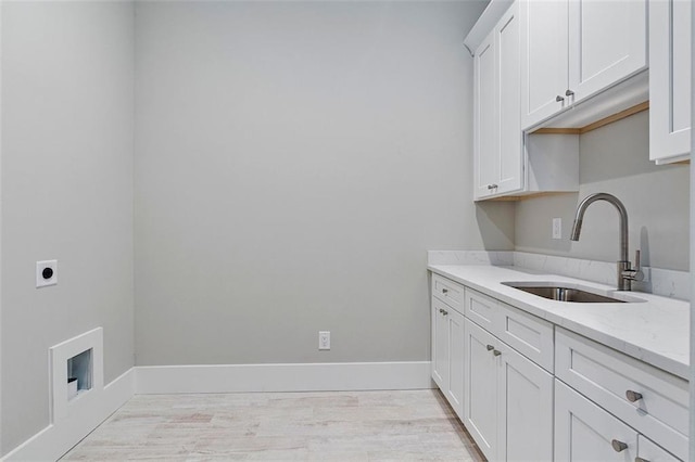 laundry area featuring light hardwood / wood-style floors, sink, cabinets, and hookup for an electric dryer