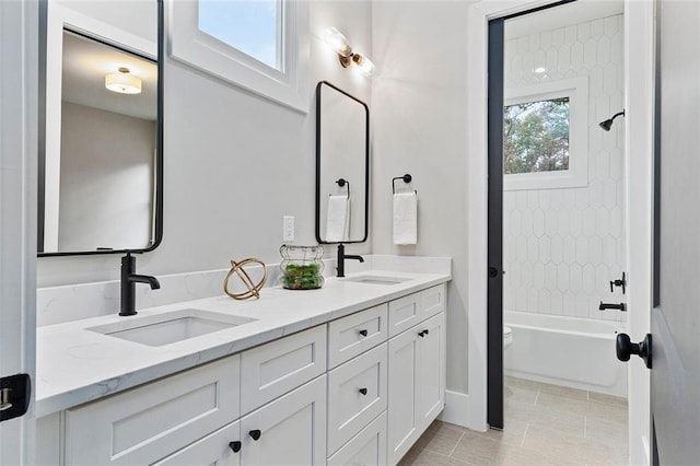 full bathroom with vanity, tile patterned flooring, tiled shower / bath combo, and toilet