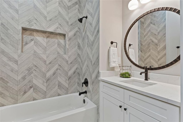 bathroom featuring tiled shower / bath combo and vanity