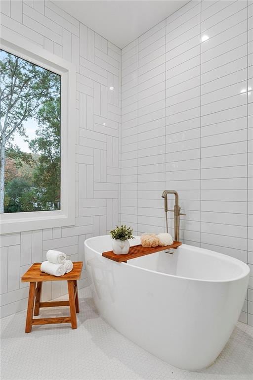 660 Timm Valley Rd NE, Atlanta, GA 30305 - bathroom featuring tile walls, tile patterned flooring, and a freestanding bath