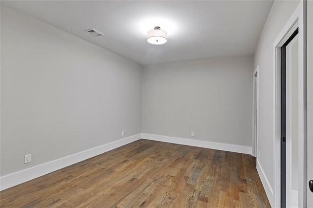 unfurnished room featuring hardwood / wood-style floors