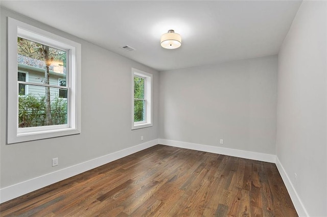 unfurnished room featuring dark hardwood / wood-style floors