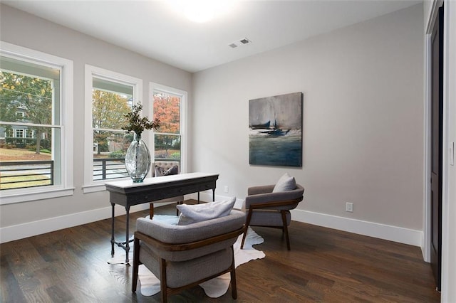 home office with dark hardwood / wood-style flooring