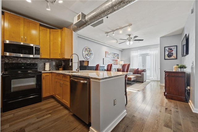 800 Peachtree St NE Unit 1504, Atlanta, GA 30308 - kitchen with stainless steel appliances, track lighting, a peninsula, a sink, and tasteful backsplash