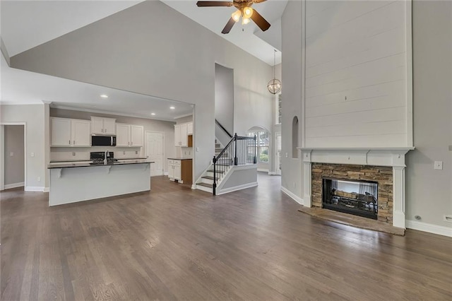 420 Gold Xing, Canton, GA 30114 - unfurnished living room featuring high vaulted ceiling, a ceiling fan, a fireplace, stairs, and dark wood-style floors