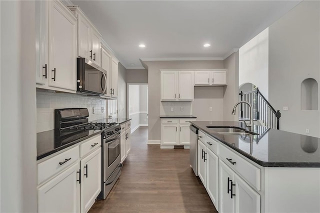 420 Gold Xing, Canton, GA 30114 - kitchen with appliances with stainless steel finishes, decorative backsplash, a center island with sink, dark wood-style floors, and white cabinets