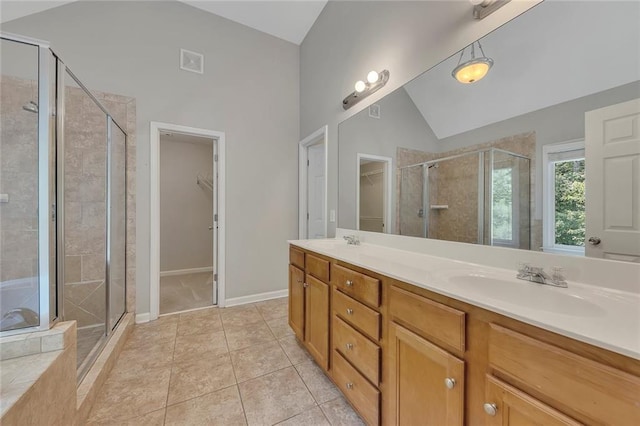 420 Gold Xing, Canton, GA 30114 - bathroom with a walk in closet, a shower stall, vaulted ceiling, double vanity, and tile patterned floors