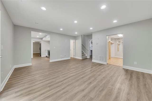 420 Gold Xing, Canton, GA 30114 - unfurnished living room featuring stairs, light wood finished floors, and recessed lighting