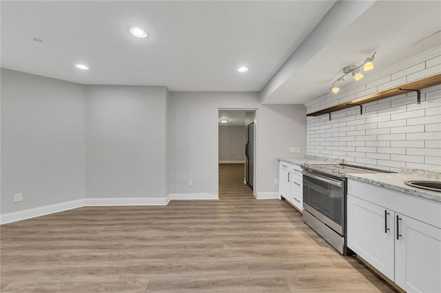 420 Gold Xing, Canton, GA 30114 - kitchen featuring stainless steel range with electric stovetop, open shelves, light stone countertops, decorative backsplash, and white cabinets
