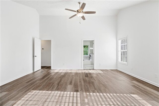 spare room with high vaulted ceiling, ceiling fan, hardwood / wood-style flooring, and a textured ceiling