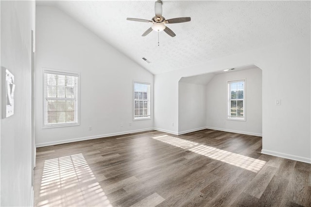 interior space featuring a textured ceiling, dark hardwood / wood-style floors, ceiling fan, and high vaulted ceiling