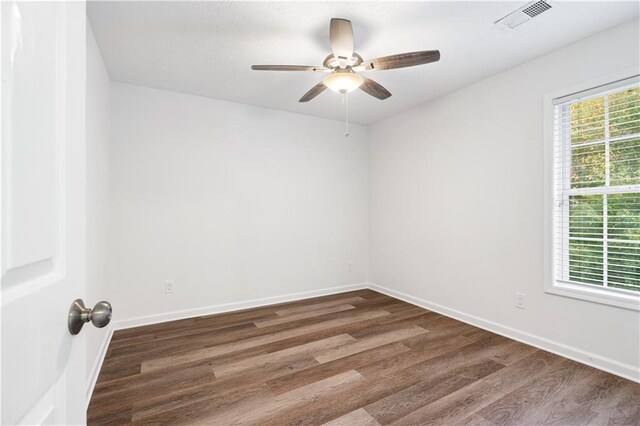 spare room featuring ceiling fan and dark hardwood / wood-style floors