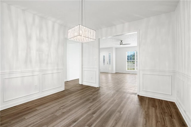 unfurnished dining area with wood-type flooring and ceiling fan