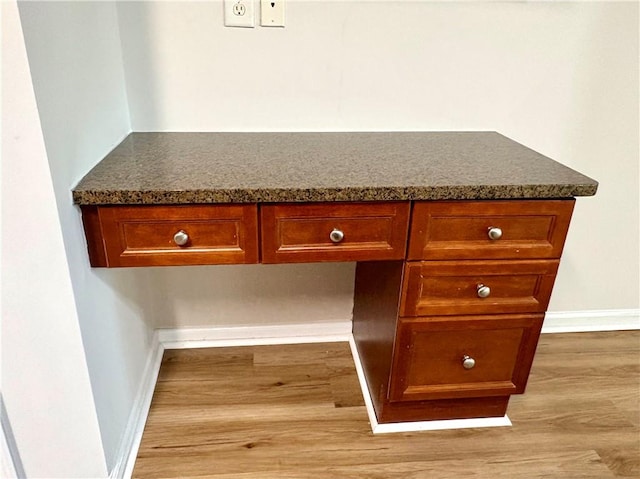 interior details featuring wood finished floors and baseboards