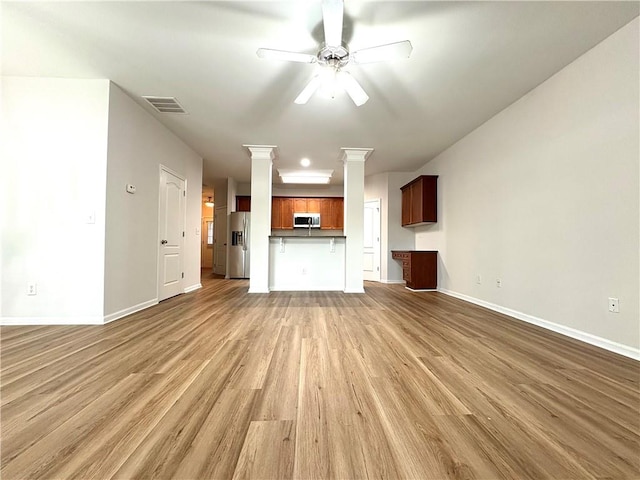 unfurnished living room with a ceiling fan, visible vents, baseboards, and light wood-type flooring