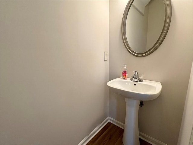 bathroom with baseboards and wood finished floors