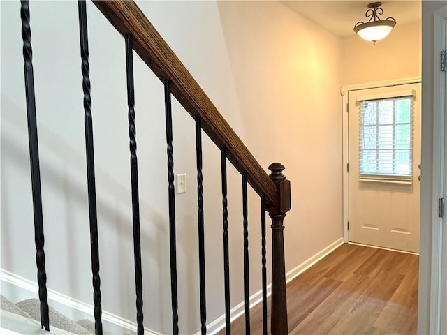 interior space featuring stairway, wood finished floors, and baseboards