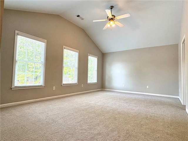 carpeted empty room with baseboards, visible vents, a ceiling fan, and lofted ceiling