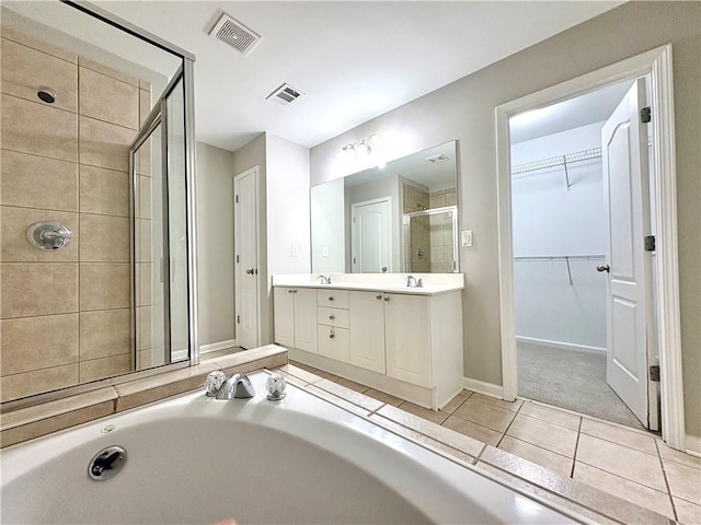 full bath with tile patterned flooring, visible vents, a shower stall, and double vanity