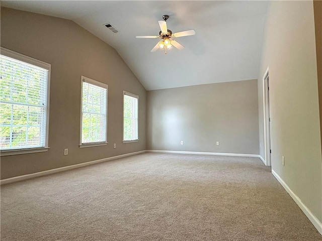 empty room with visible vents, ceiling fan, carpet flooring, and vaulted ceiling