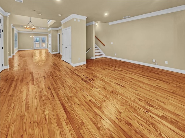 unfurnished living room featuring light wood-type flooring, a notable chandelier, ornamental molding, stairway, and baseboards