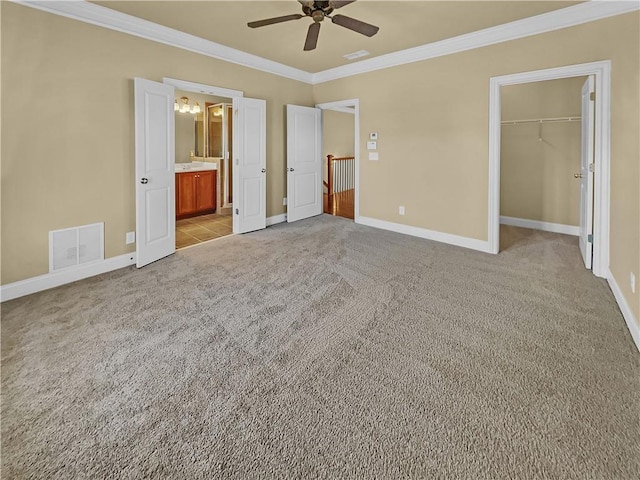 unfurnished bedroom featuring baseboards, light colored carpet, visible vents, and ornamental molding