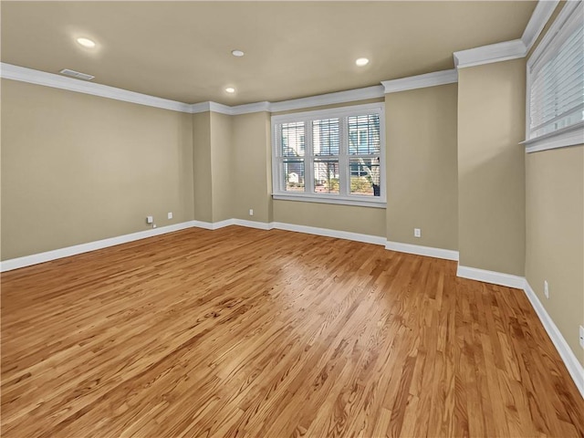 spare room featuring recessed lighting, light wood-style flooring, baseboards, and ornamental molding