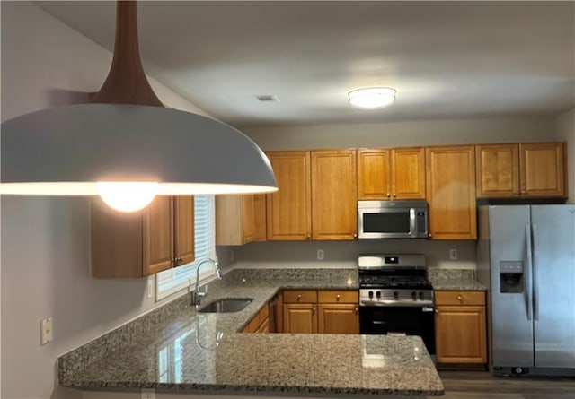 1415 Stoney Field Pl, Lawrenceville, GA 30043 - kitchen featuring appliances with stainless steel finishes, a sink, stone counters, a peninsula, and dark wood-style floors