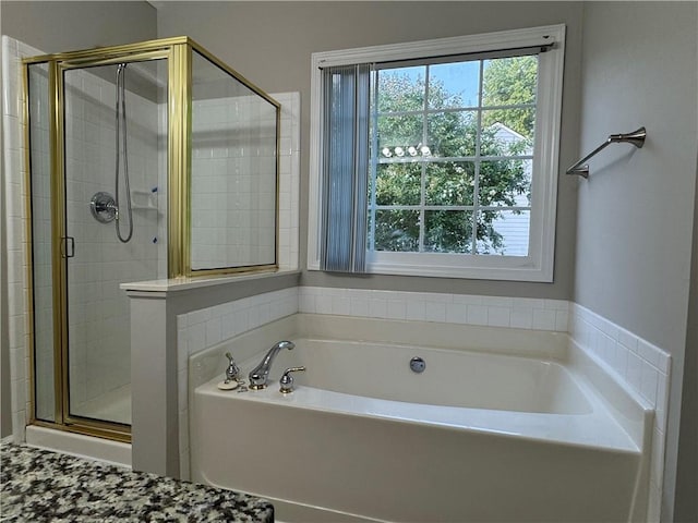 1415 Stoney Field Pl, Lawrenceville, GA 30043 - bathroom with plenty of natural light, a bath, and a stall shower