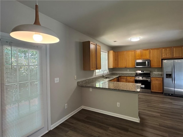 1415 Stoney Field Pl, Lawrenceville, GA 30043 - kitchen featuring stainless steel appliances, a sink, stone counters, a peninsula, and brown cabinets