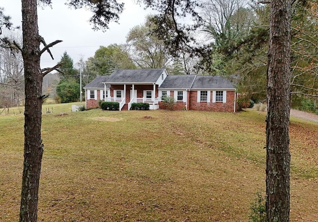 single story home with a porch and a front lawn