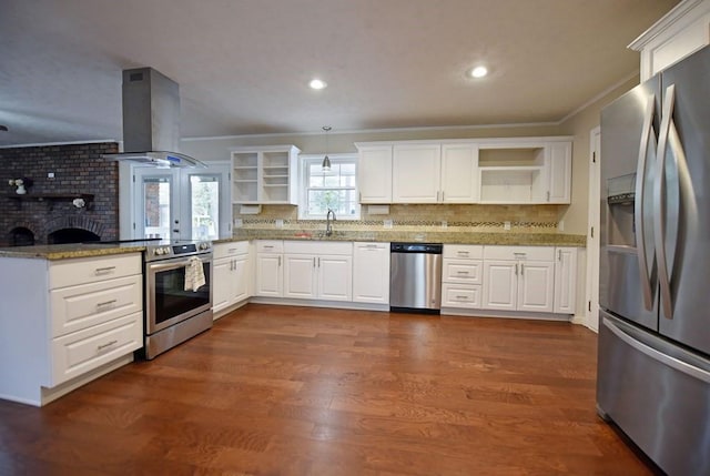 kitchen featuring dark wood-type flooring, white cabinets, wall chimney exhaust hood, appliances with stainless steel finishes, and kitchen peninsula