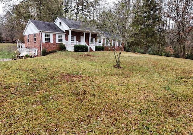 view of front of house with covered porch and a front yard