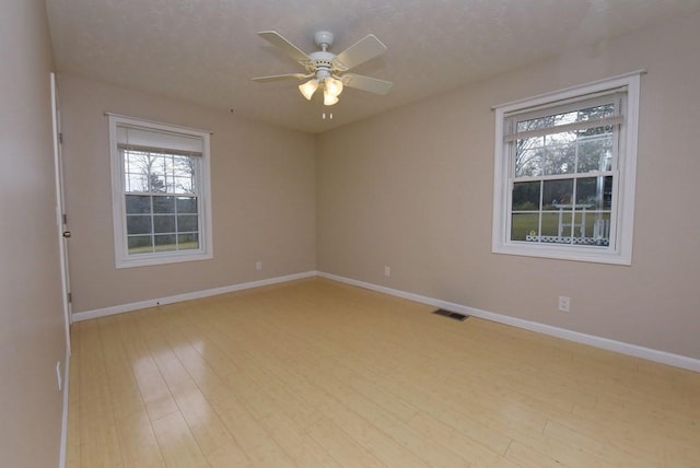 spare room with light hardwood / wood-style floors and ceiling fan