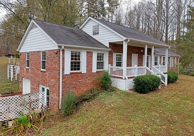 view of front of home with a porch, a garage, and a front lawn