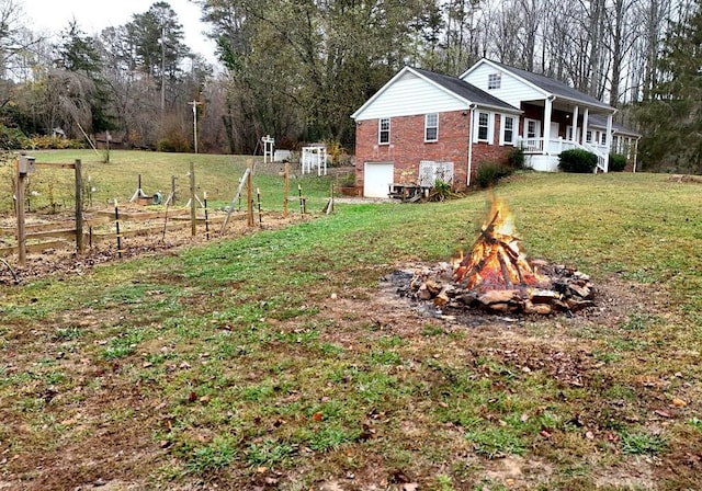 view of yard featuring covered porch and a garage