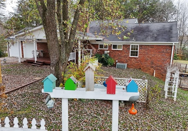 rear view of property with central air condition unit