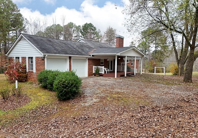 single story home featuring covered porch and a garage