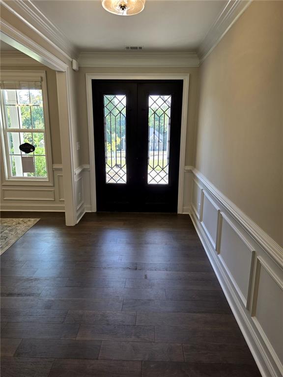 7260 Bluewater Ln, Douglasville, GA 30135 - foyer with crown molding, a wainscoted wall, and a decorative wall