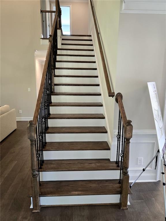 7260 Bluewater Ln, Douglasville, GA 30135 - staircase with wood finished floors, baseboards, and crown molding