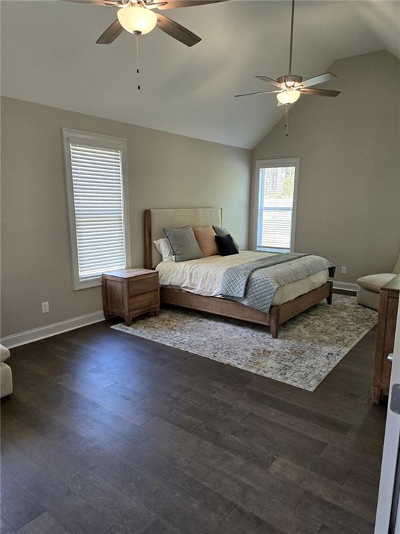 7260 Bluewater Ln, Douglasville, GA 30135 - bedroom with vaulted ceiling, a ceiling fan, baseboards, and dark wood-style flooring