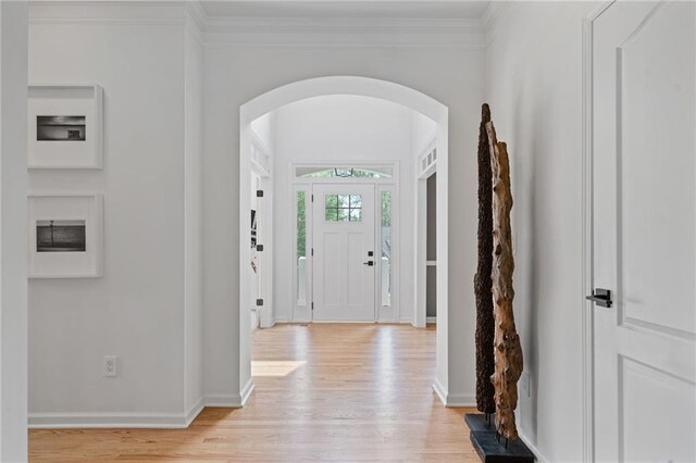 4030 Scenic View Ct, Cumming, GA 30028 - entrance foyer featuring ornamental molding, arched walkways, baseboards, and light wood-style floors
