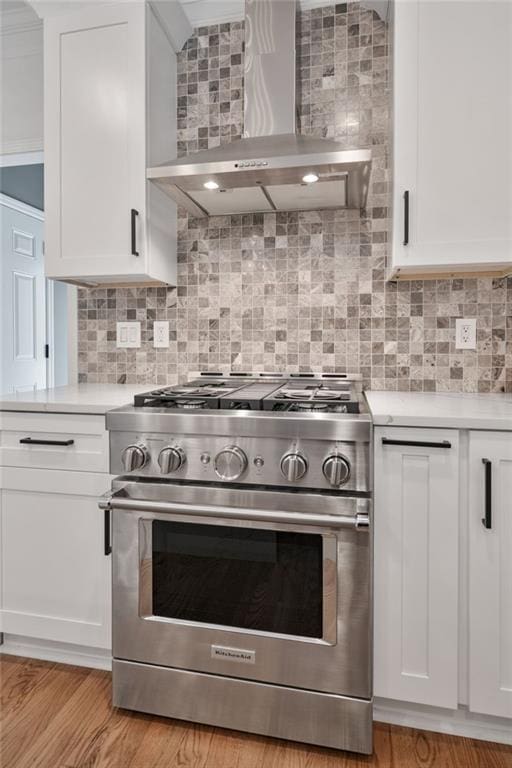 4030 Scenic View Ct, Cumming, GA 30028 - kitchen with white cabinetry, tasteful backsplash, light countertops, stainless steel range, and wall chimney exhaust hood