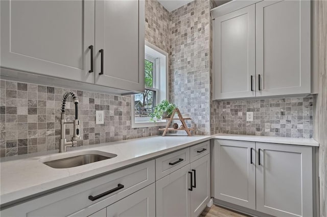 4030 Scenic View Ct, Cumming, GA 30028 - kitchen featuring light stone countertops, backsplash, and a sink