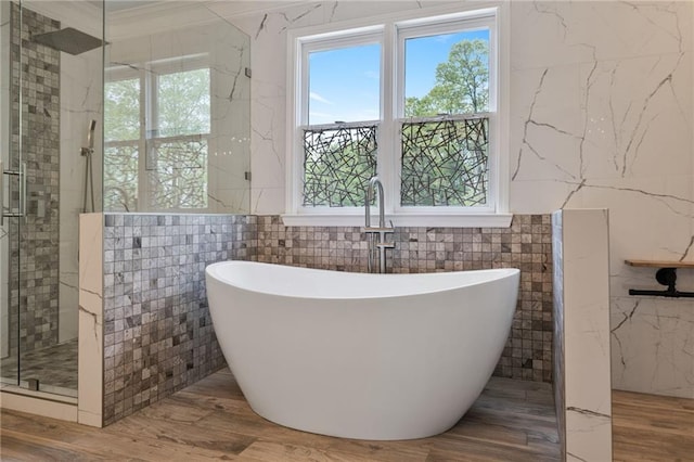 4030 Scenic View Ct, Cumming, GA 30028 - full bath with tile walls, a freestanding tub, wood finished floors, and a shower stall