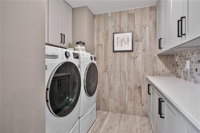 4030 Scenic View Ct, Cumming, GA 30028 - laundry room with washer and dryer, cabinet space, and light wood finished floors