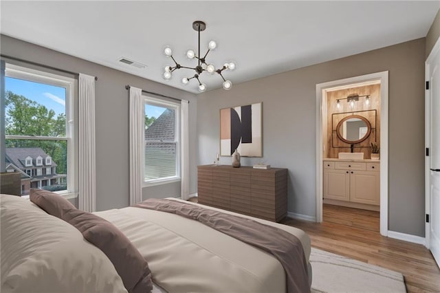 4030 Scenic View Ct, Cumming, GA 30028 - bedroom with light wood-style floors, a notable chandelier, ensuite bath, visible vents, and baseboards