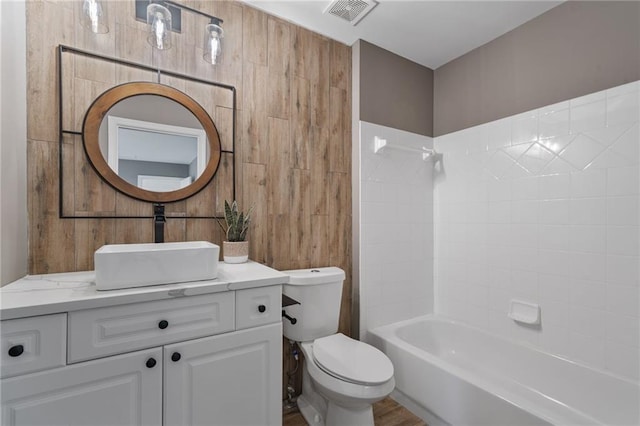 4030 Scenic View Ct, Cumming, GA 30028 - bathroom featuring wood walls, toilet, shower / bathtub combination, vanity, and visible vents