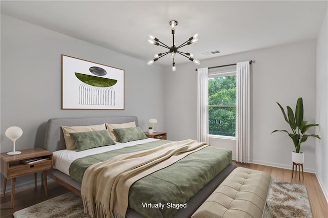 4030 Scenic View Ct, Cumming, GA 30028 - bedroom featuring wood finished floors, visible vents, a chandelier, and baseboards